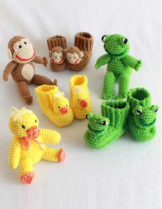 several crocheted stuffed animals and baby shoes