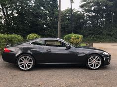 a black sports car parked in a parking lot