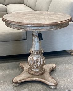 an old wooden table sitting in front of a couch