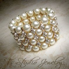 the bracelet is adorned with pearls and crystal stones