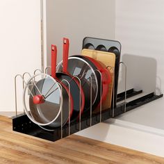 there are many plates and pans in the holder