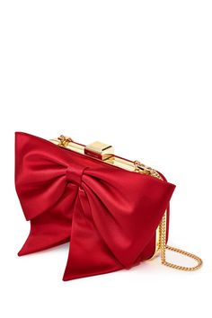 Prepare to fall in love with the Cupid’s Clutch - our clever way of avoiding “the bow” in the room.  A fully framed convertible clutch with a silver finish, an interior pocket, and a removable chain with a top closure, she is sure to make an entrance.  Its statement bow detailing combined with its holly red duchess satin makes this clutch a perfect choice for your next night out.Details:7.68" L X 2.36" W X 4.9" HClasp ClosureOuter: Duchess SatinInner: Satin LiningOptional Metal Chain included wi Elegant Bags With Decorative Bow, Evening Bags With Bow Detail, Classic Evening Bag For Parties, Elegant Formal Bag With Satin Bow, Elegant Clutch Bag With Bow, Elegant Evening Bag With Satin Bow, Elegant Bags With Bow For Party, Elegant Evening Bags With Satin Bow, Chic Formal Bags With Satin Bow