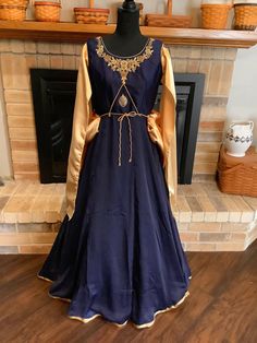 "This is a designer Renaissance dress in navy blue and gold.  Dress zips up side.  Chest is heavily hand embroidered.  Tie on bussel.  Sleeves drape with navy embroidery at shoulders.  Medallion in middle of chest with cording.  Chest 40\", waist 32\", length 54\". You will never see another like this." Traditional Dress With Embroidered Sleeves And Drape, Royal Fitted Dress With Resham Embroidery, Navy Blue And Gold Dress, White Medieval Dress, Fem Clothing, Historic Dresses, Historical Outfits, Blue And Gold Dress, Fair Outfit