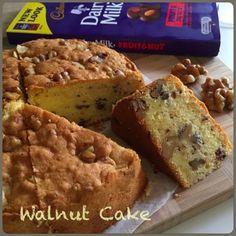 the cake is cut into slices and ready to be eaten with nuts on top, along with a bar of chocolate