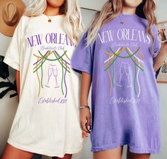 two women standing next to each other wearing new orleans nightshirt t - shirts