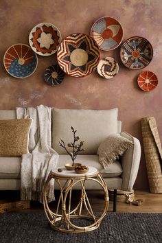 a living room filled with furniture and plates on the wall