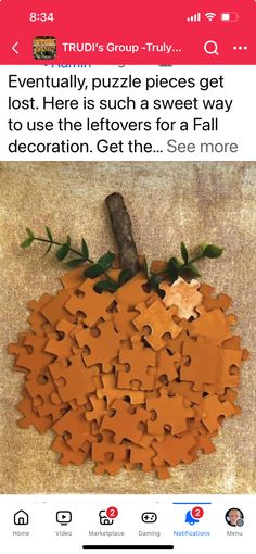 an orange puzzle piece sitting on top of a floor next to a wooden sticker