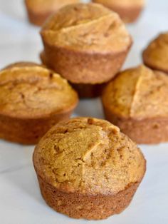 several muffins sitting on top of a white table