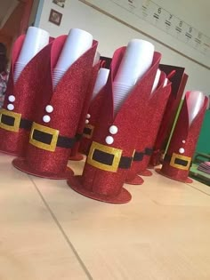 some red and white paper hats sitting on top of a table