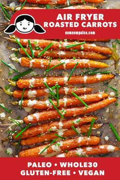 roasted carrots with white sauce and green onions on a baking sheet for an air fryer roasted carrots recipe