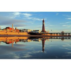 a pier with a tower in the middle of it and buildings on either side of it