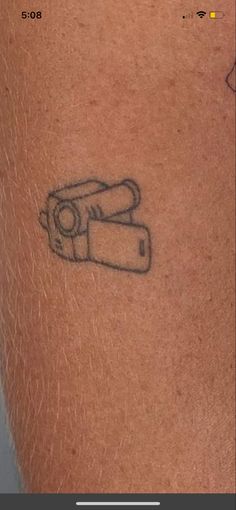 a tattoo with a camera on it