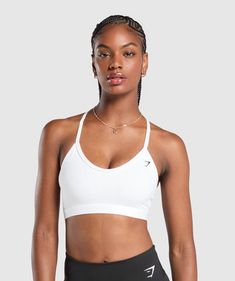 IT'S NOT YOU, IT'S YOUR SPORTS BRA With lightweight, breathable designs, comfortable cups and supportive straps, you can rely on our sports bras to be there for you, and for yours. • Classic racerback shape• Removable padding to wear it how's comfiest for you• Elegant plunging V-neck• Secure elastic straps to support you throughout lifting and life SIZE & FIT• Low support• Body fit• Model is 5'9" and wears a size S MATERIALS & CARE• 78% Nylon, 22% Elastane SKU: B2A7E-WBBM Supportive Sports Bra With Breathable Fabric, Sporty Racerback Training Bra, White Breathable Gym Bra, White Breathable Bra For Workout, Breathable Sporty Racerback Bra, Sporty Supportive White Bra, White Workout Bra With Light Support, White Sports Bra For Athleisure, Sporty Workout Bra With Adjustable Straps