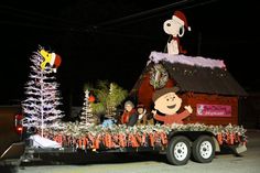 a float with peanuts on it's back and christmas decorations in the front yard