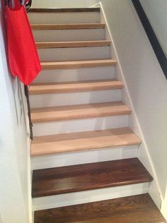 the stairs are made of wood and have been painted white with dark brown stain on them