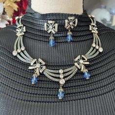 Hdj4014: Heidi Daus Choker Style Necklace. Curved Double Bar With Graduated White Crystal On Each Bar. Next Link Has Blue And While Multi Shaped Faceted Crystals. Next Link Has Three Bars With Graduate White Crystal On Each Bar. Following Three Links Continues The Sequence And These Three Links Also Has A Blue Briolette Drop From The Bottom Of The Link. Matching Earrings That Have The Multi Shaped Beads And A Blue Briolette Drop From The Bottom Of The Earring. For Pierced Ears Only. Necklace Can Be Worn As A 16" Choker Or Longer With The 4" Extender. Colors Of The Stones Are Periwinkle Blue And Clear. No Missing Stones, Clasps, Omega Back For Earrings Are In Perfect Working Condi Choker Style Necklace, Heidi Daus, Choker Style, Necklace And Earring Set, Periwinkle Blue, White Crystal, Cornflower Blue, Faceted Crystal, Style Necklace