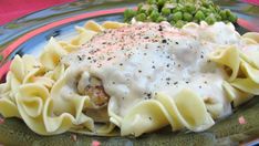 a green plate topped with pasta and peas