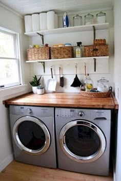 a washer and dryer in a small room with open shelving on the wall