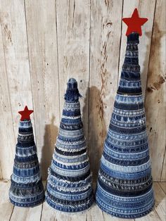 three small blue and white christmas trees with red stars