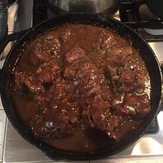 a pot full of stew sitting on top of a stove