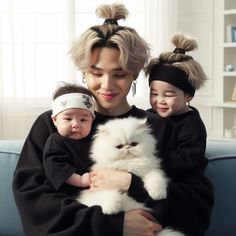 a woman holding two small children and a white cat in her arms, both wearing headbands