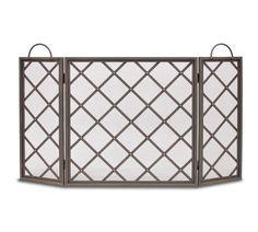 an iron fireplace screen with white glass panels