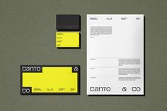 some yellow and black business cards on top of a gray surface with the letter q