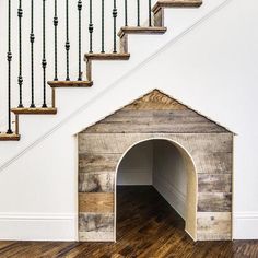 a dog house made out of pallet wood with stairs and railings on the side