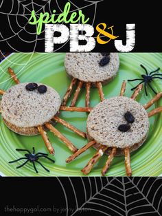 some kind of sandwich on a green plate with spider webs and black widowes