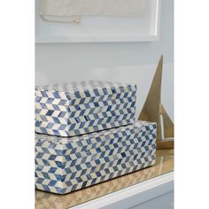 two blue and white boxes sitting on top of a counter