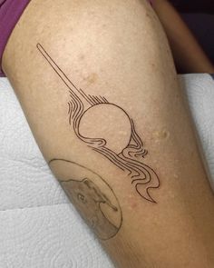 a woman's leg with a tattoo on it that has an image of the sun and saturn