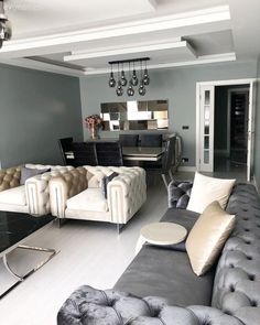 a living room filled with furniture and a chandelier