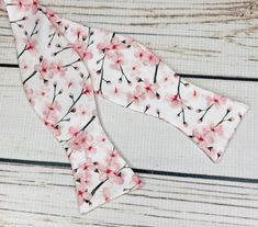 "Pale pink cherry blossoms on white cotton sateen. Because of the handmade nature of these bowties they can vary in size ever so slightly but on average the bow measures 5 inches by 2 inches when tied. hand wash/ spot wash only The self-tied option will be made in the style pictured. The pre-tied option will have the addition of a hook in the back, and the bow will be stitched in the tied position. RETURNS: I accept returns on items in original, unused condition. You will receive a refund for th Elegant White Bow Tie For Spring, Pink Bow Tie For Spring Formal Occasions, Pink Bow Tie For Spring Formal Events, White Satin Bow Tie For Spring, Mens Bowtie, Cherry Blossom Wedding, Cherry Blossom Festival, Pink Cherry, Lovely Print