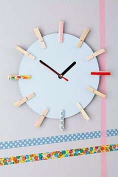 a clock made out of clothes pegs and tape