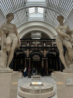 two statues in the middle of a building