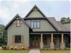 a gray house with brown shutters on the front door and windows in the side