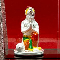 a glass case with a figurine of a man holding a soccer ball