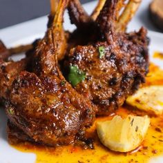 some meat and potatoes on a white plate