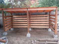 a wooden fence with concrete pillars and posts on the sides, in an outdoor area