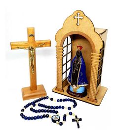 a wooden cross, rosary and statue of the virgin mary