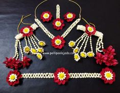 red and yellow flowers are attached to white beads