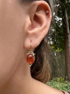 Wowza! That's all we can say about these insane Indian Sunstone Cabs. Set in 14k yellow gold with gold ear wires and delicate granulation these beauties will capture everyone's eye. Approximate stone size: 11mm x 9mm Approximate stone weight:8.5cts Mohs Hardness scale:6 This one of a kind piece is handmade to order in Emily's Hudson Valley studio. If you have questions about sizing, shipping or custom orders please reach out to us! Sunstone Earrings, Mohs Hardness Scale, Hardness Scale, Local Jewelry, Hudson Valley, Ear Wires, Custom Orders, My Jewellery, Ring Size