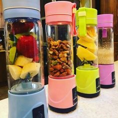 three blenders filled with different types of fruit and nuts on a counter top next to each other