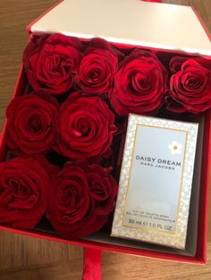 a box with red roses in it and a small card on the inside that says daisy dream