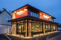 the outside of a restaurant at night with lights on