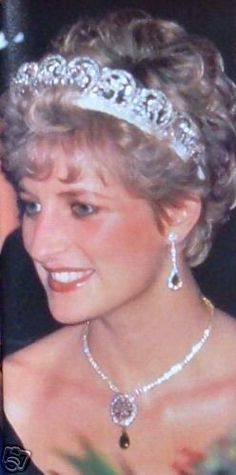 a woman wearing a tiara and smiling for the camera