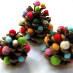 three pine cones decorated with colorful beads