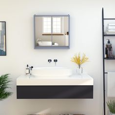 a bathroom with a sink, mirror and towel rack on the wall next to it