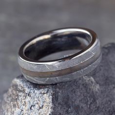 a wedding ring sitting on top of a rock