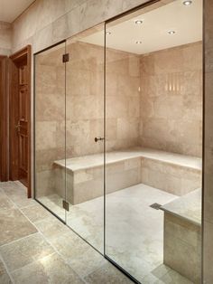 a bathroom with a walk in shower next to a bath tub